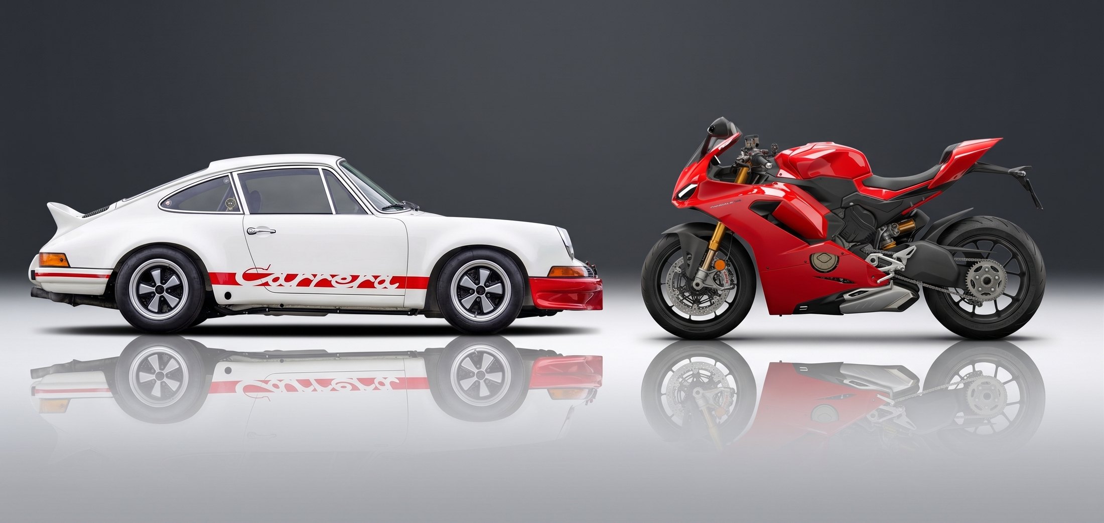 A Porsche 911 Carrera RS 2.7 and a Ducati Panigale, facing each other